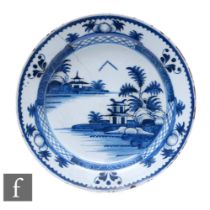 An 18th Century Lambeth English Delft pottery plate, the central well hand painted with a