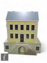 A late 20th Century painted Georgian style wooden dolls house painted in yellow and grey with