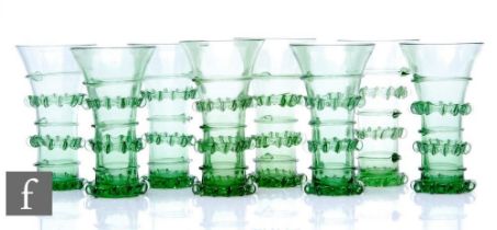 A set of contemporary hand blown reproduction green drinking glasses in the style of a German