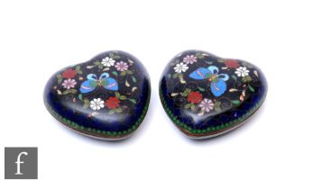 A pair of 19th Century cloisonné heart shaped pin dishes, floral inset decoration on a black ground,