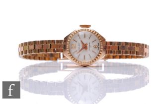 A lady's 9ct hallmarked manual wind Victor wrist watch to an integral 9ct brick bracelet, total