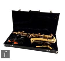 A brass saxophone by Signature series, cased.