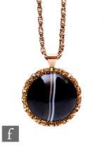 A 9ct mounted circular banded agate pendant suspended from an early 20th Century 9ct fancy belcher