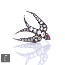 A 19th Century silver gilt diamond set brooch modelled as a swallow with a single set ruby eye,