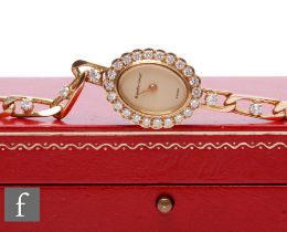 An 18ct lady's Bueche Girod quartz wrist watch, oval champagne dial within diamond set border to
