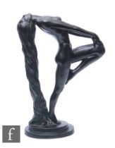 A 20th Century black painted Art Deco style figure of a naked female reclining and holding her knee,