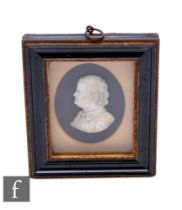 A 19th Century carved side profile bust of Benjamin Franklin, possibly wax, in oval mount and
