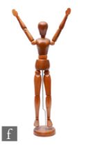 A 20th Century wooden articulated artist's mannequin, height 44cm.