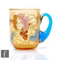 A late 19th Century Moser glass punch cup, the amber body enamel and gilt decorated with leaves