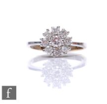 An 18ct hallmarked white gold diamond cluster ring, central diamond within a border of eight further