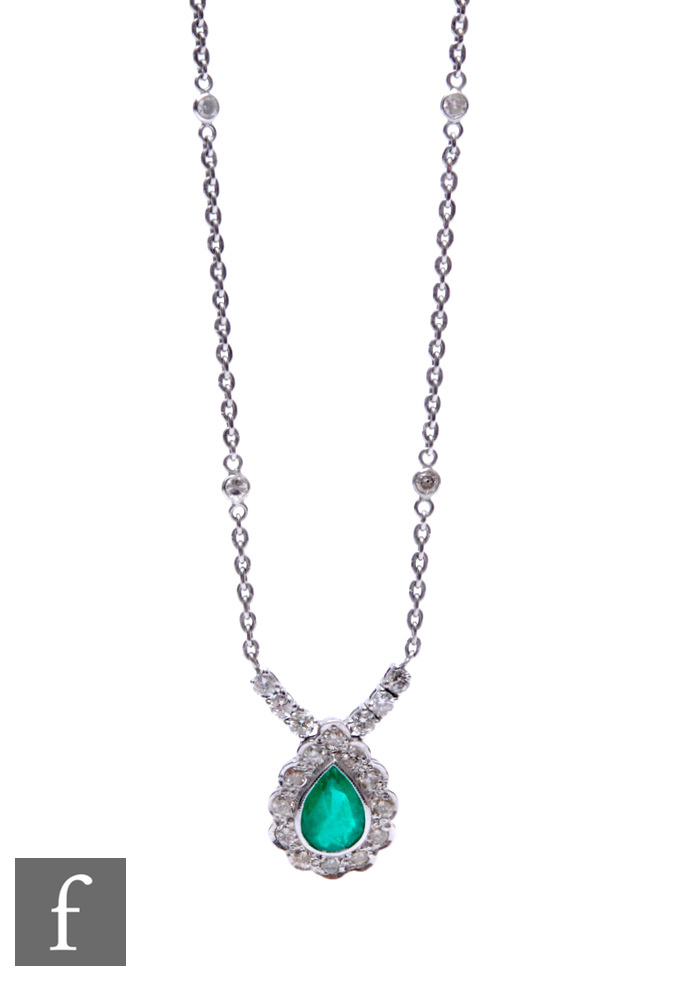 An 18ct white gold emerald and diamond pendant, tear shaped emerald within a border of twelve - Image 2 of 2
