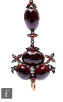 A 19th Century silver gilt garnet and diamond pendant/brooch, comprising four cabochon garnets