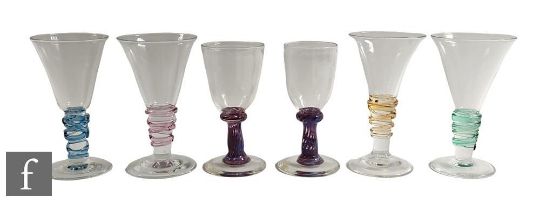 A pair of late 20th Century studio glass wine glasses by Anthony Stern, the lipped round funnel bowl
