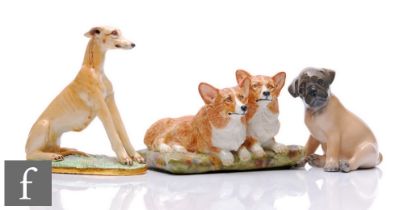 Two Basil Matthews models of dogs comprising a pair of corgis seated on a cushion and a seated