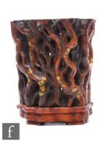 A Chinese late Qing Dynasty carved hardwood brushpot bitong, the carved sides formed from