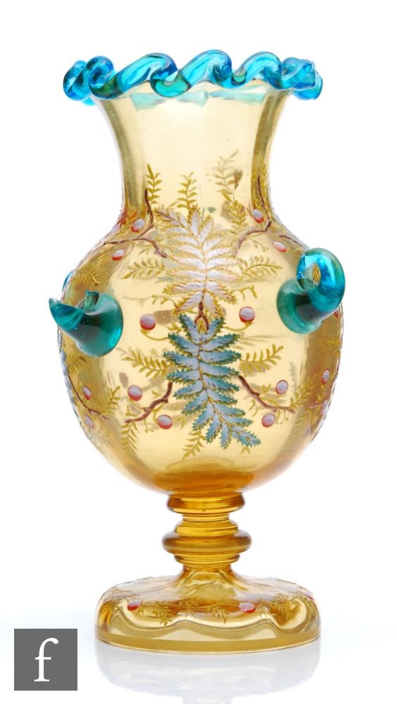 A late 19th Century Harrach continental amber glass vase of footed ovoid form with flared collar
