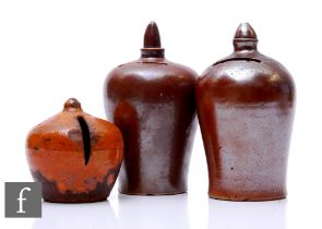 A 19th Century salt glazed stoneware money box of shouldered ovoid form with finial mount, height