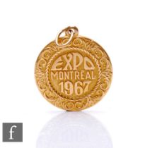 A 14ct circular pendant, Expo Montreal 1967, weight 3g.