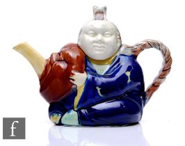 A 19th Century English Majolica teapot after Minton, modelled as a seated Asian gentleman in a