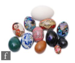 A collection of darning eggs and decorative eggs, to include a transfer printed example with