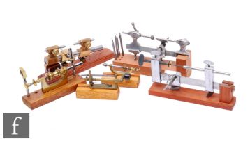 Six early 20th Century watch maker's lathes and tools, each on a mahogany plinth base. (6)