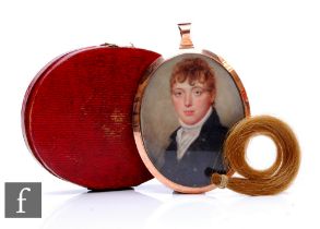 An oval shoulder study of a young man to a 9ct mount, plaited hair panel to reverse, total weight