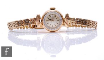 A lady's 9ct Omega manual wind wrist watch, batons to a circular silvered dial, all to a 9ct gate