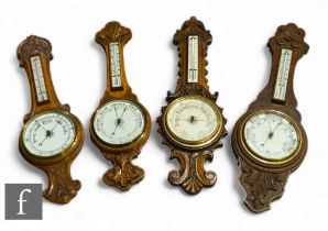 Four various carved oak circular aneroid barometers, each incorporating thermometers, height 88cm,