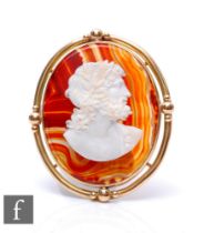 A 19th Century 9ct mounted hardstone cameo. profile of a classical man, to a banded agate base,