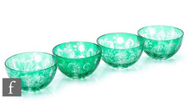 A set of four early 20th Century Stevens and Williams finger bowls, cased in green over clear and
