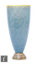 A Phoenix Glass Company vase of flared form in mottled blue with applied yellow rim and foot