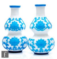 A pair of early 20th Century Peking Cameo glass vases, each of double gourd form, cased in