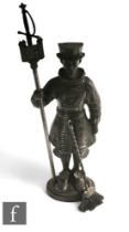 A 20th Century cast iron companion set modelled as a Beefeater holding a castellated standard