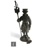 A 20th Century cast iron companion set modelled as a Beefeater holding a castellated standard