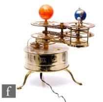 A modern brass battery operated orrery, with earth, moon and the sun, height 35cm.