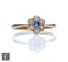 An early 20th Century sapphire and diamond seven stone daisy cluster ring, central sapphire within a