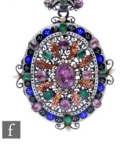 A 19th Century Austro Hungarian silver oval brooch set with rose quartz, emeralds and seed pearls