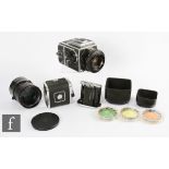 A Hasselblad 2000FC medium format camera with further batteries and accessories.