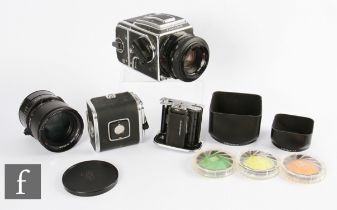 A Hasselblad 2000FC medium format camera with further batteries and accessories.