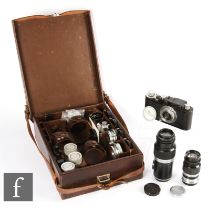 A Leica III set, comprising camera body, various lenses and accessories in fitted case.