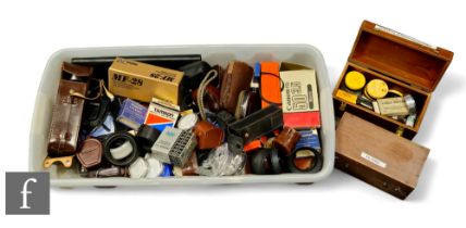 A large quantity of various camera accessories including filters, light meters, lens hoods, exposure