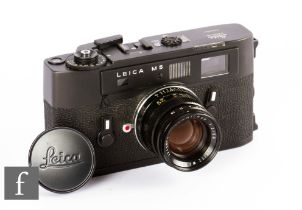 A Leica M5 camera with summicron f2/50 lens, black body, serial number 1290483.
