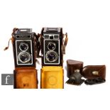 Two Zeiss Ikon Ikoflex TLR cameras, with cases and additional lenses.