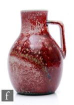 Ruskin Pottery - A 1930s pottery jug of shouldered ovoid form with collar neck and angular handle,