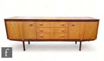 White & Newton Furniture - A mid Century teak sideboard, the plank top above three short drawers and