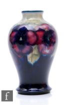 William Moorcroft - Pansy - A vase of baluster form with narrow collar neck circa 1920, tubeline