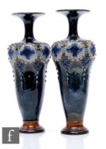 Royal Doulton - A pair of early 20th Century stoneware vases of slender shouldered ovoid form with