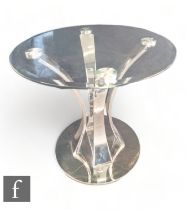 Unknown - A contemporary chrome plated coffee table with arched supports below a circular glass top.