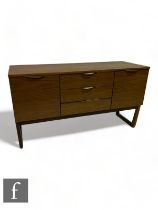 Unknown - A mid Century sideboard, the central three doors flanked by two hinged cupboards, raised
