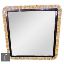 In the Manner of Anthony Redmile - A polished horn wall mirror of square section, the polished black
